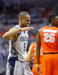 Markel Starks #5 of the Georgetown Hoyas celebrates after a win as Rakeem Christmas #25 of the Syracuse Orange walks off the court.