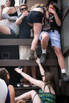 Students help each other climb onto a ledge at Castle Court.