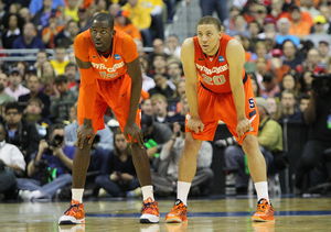 Baye Moussa Keita (left) and Brandon Triche (right) set up the Orange's impenetrable 2-3 zone. Syracuse held Marquette to 3-of-24 shoot from beyond the arc.