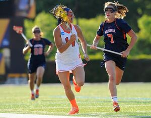 Syracuse defender Kasey Mock carries the ball upfield in the Orange's 16-8 semifinals win over Virginia on Friday. Mock and the rest of the Orange defense kept the Cavaliers attack in check for the entirety of the game. 