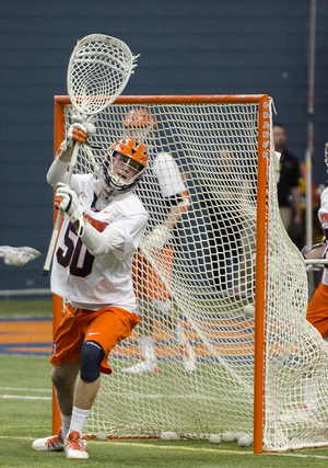 After starting 33 games for Syracuse from 2012–14, Dominic Lamolinara’s aspirations to have a coaching career are now underway as he mentors SU’s goalies in anticipation of the spring season.