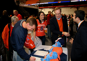 Chancellor Kent Syverud talks to bidders at the Syracuse University Sport Management Club’s 10th annual charity sports auction, held Dec. 6. The auction made more than $40,000 for Make-A-Wish of Central New York.  