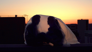 As part of Xuan Liu’s project “Iceberg Project,” Liu (right) read “Hugging Meditation” by Thich Nhat Hanh to her friend Yizhe Ye under a plastic covering. 