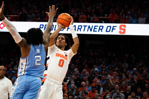 Chris Bell attempts a fadeaway shot over North Carolina's Caleb Love. During his freshman season at Syracuse, Bell averaged 6.6 points and totaled a season-high 17 against Notre Dame