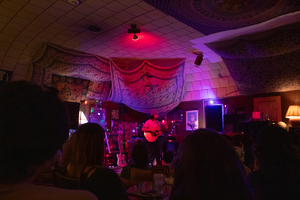 Local artist Jack Stinziano plays an acoustic set at CrossRoad Collective’s Acoustic Evening. The event cultivated a space for people from Syracuse University and the city to meet each other and listen to multiple artist performances.