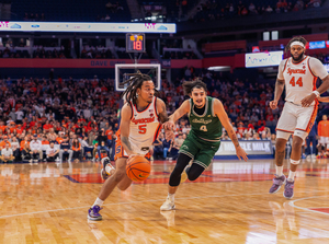 Syracuse point guard Jaquan Carlos (pictured, No. 5) dished out a team-high six assists to help the Orange narrowly defeat Le Moyne in their 2024-25 season opener.