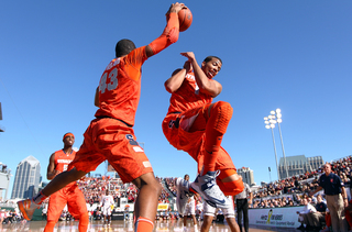 Michael Carter-Williams (right) of the Syracuse Orange jumps out of the way as teammate James Southerland reaches to keep the ball in bounds against the San Diego State Aztecs during the Battle on the Midway game on Sunday.