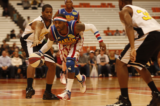 Woody bursts by two Select defenders in the first half of the Globetrotters' 114-100 win Friday at the Carrier Dome. 