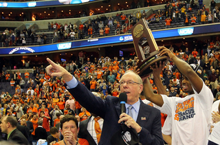 Head coach Jim Boeheim of the Syracuse Orange speaks to the crowd as C.J Fair #5 holds up the trophy after their win over the Marquette Golden Eagles.