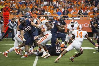 Orange running back Jerome Smith busts through a pile of defenders.