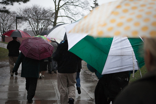 Members of the Syracuse community  proceed to the Wall of Remembrance following the  service. 