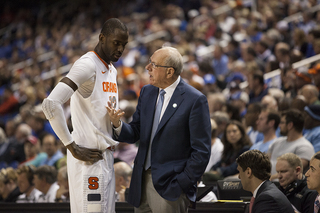 SU head coach Jim Boeheim talks with Keita as he comes to the bench. 