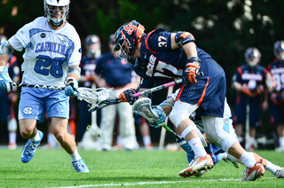 Williams fights for a loose ball as Tar Heels midfielder Tate Jozokos looks on.