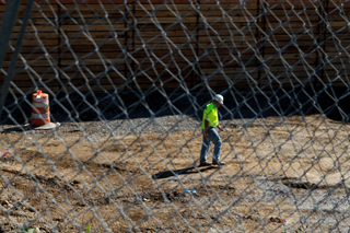 A worker walks through the South Crouse Avenue construction site. Photo taken Aug. 8, 2017