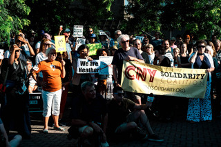 Throughout the rally, people were fanning themselves due to humidity. 