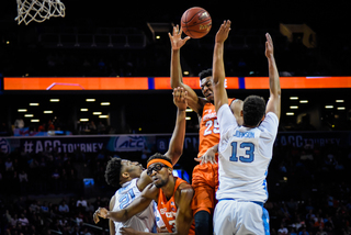 Battle rises up against UNC's Cameron Johnson (13). On the other end, Johnson scored 13 points for UNC. 