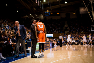 Assistant coach Gerry McNamara chats with senior guard Howard.