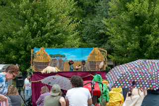 Catskill Puppet Theater puts on a performance for members of the audience. Even in the rain, families gathered on the hay bales to sit and watch the show. 